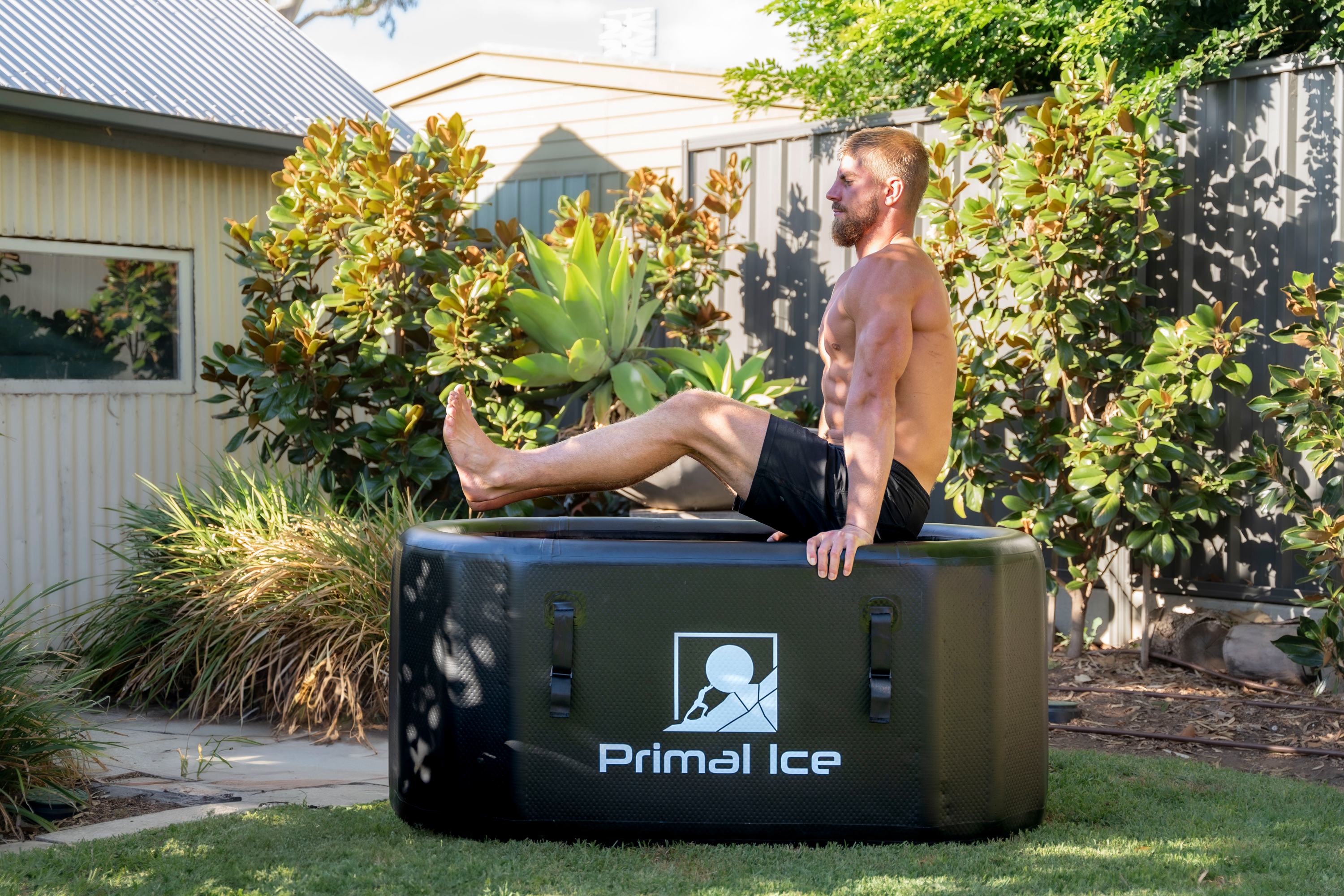 man doing L sit hold over ice bath tub